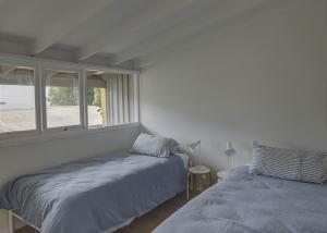 a bedroom with two beds and a window at Norah Beach Shack 2 in Norah
