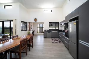 a kitchen with a long table and a dining room at Solana Properties in Nadi