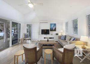 a living room with a couch and a table at Relaxing Getaway in Summerland Point