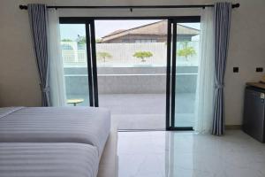 a bedroom with a bed and a sliding glass door at Northerly นอร์ทเทอร์ลี่ in Chiang Rai +32 photos