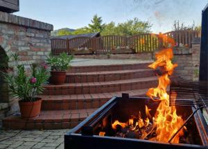 a fire pit with flames coming out of it at Panoráma Villa Vágáshuta in Vágáshuta