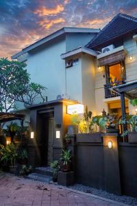 a house with a lot of plants in front of it at Songbird Boutique Inn in Canggu