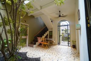 a hallway with a staircase and a table with chairs at Songbird Boutique Inn in Canggu