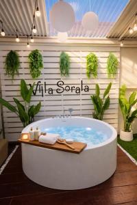 a bath tub in a garden with plants at Villa Luna and Villa Solara in Koh Samui