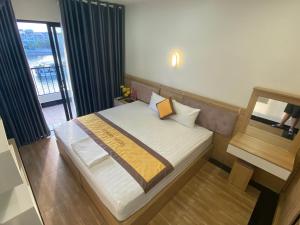 a small bedroom with a bed with a window at A59 Memory Hotel Tuan Chau in Ha Long