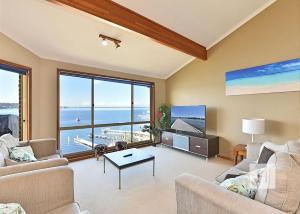 a living room with a view of the ocean at Sparkling Waters in Rathmines