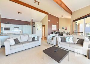 a living room with two couches and a table at Sparkling Waters in Rathmines