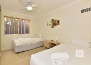 a bedroom with two beds and a window at Sparkling Waters in Rathmines