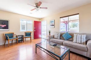 a living room with a couch and a table at Old Town Cottonwood Cottage in Cottonwood
