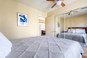 a bedroom with a large bed and a mirror at Old Town Cottonwood Cottage in Cottonwood