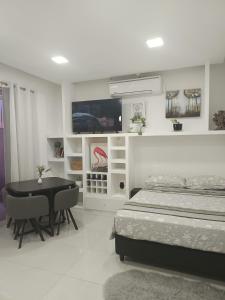 a bedroom with a bed and a table and a tv at Monoambiente Dos Lunas in Resistencia