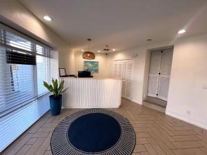an office with a table and a blue rug in a room at Chateau Mar Beach Hotel NEWLY REFURBISHED in Ormond Beach