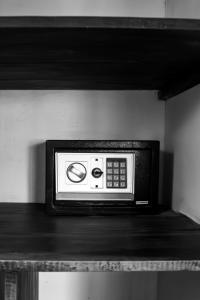 a microwave sitting on top of a shelf at Bungalow du Lagon in Ambaro