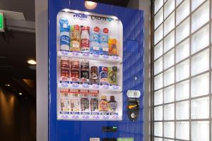 a vending machine filled with lots of bottles of soda at HOTEL MYSTAYS Ueno East in Tokyo