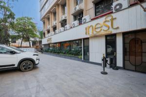 a white car parked in front of a building at Hotel Silver Inn Near Mumbai Airport in Mumbai