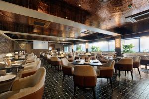 a restaurant with tables and chairs in a room at Hotel Silver Inn Near Mumbai Airport in Mumbai +42 photos