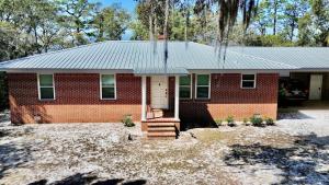 a red brick house with a white door at Bayfront- 2mins from Boat Launch in Eastpoint