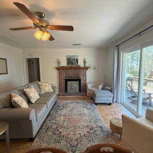 a living room with a couch and a fireplace at Bayfront- 2mins from Boat Launch in Eastpoint
