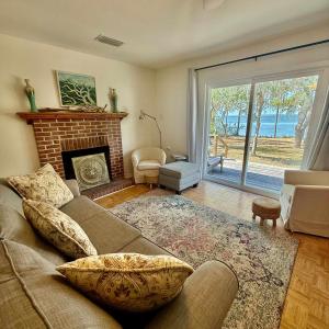 a living room with a couch and a fireplace at Bayfront- 2mins from Boat Launch in Eastpoint +30 photos