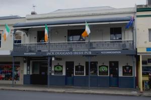 a building with flags in front of it on a street at Jack Duggans Pub in Bathurst