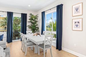 a dining room with a white table and chairs at 50 8th Avenue in Indialantic