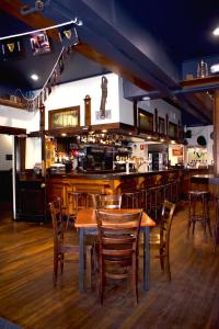 a bar with wooden tables and chairs in a restaurant at Jack Duggans Pub in Bathurst