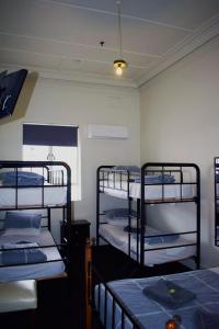 a room with three bunk beds in it at Jack Duggans Pub in Bathurst