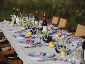 a long table with glasses and bottles of wine at La Terra Resort in Shiojiri