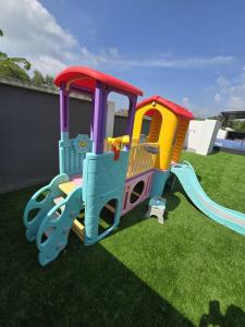 a toy train on the grass in a yard at Infra Homestay 1 in Marang +3 photos