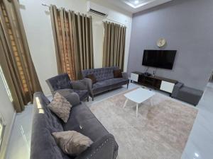 a living room with a couch and a tv at Infra Homestay 1 in Marang