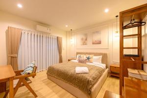 a bedroom with a bed and a table and a desk at Villa Luna and Villa Solara in Koh Samui