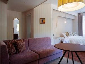 a living room with a couch and a bed at Hotel Espacio 山口 -ADULT ONLY- in Yamaguchi