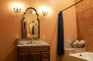 a bathroom with a sink and a mirror at The Olivier House Hotel in New Orleans +43 photos