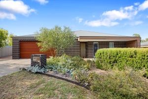 a home with a brick house with a garage at Spacious 4-Bedroom Retreat in Mansfield