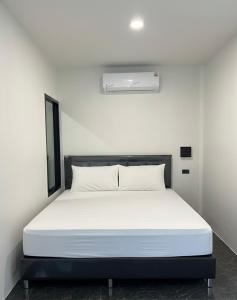 a bed in a white room with a white mattress at The Forest Pool villa & cafe in Ban Wang Yao