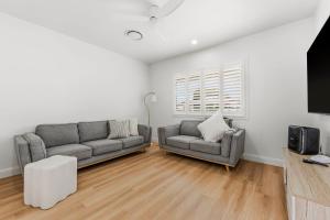 a living room with two couches and a tv at Thirty Eight in North Haven