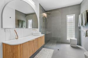 a bathroom with a sink and a bath tub at Thirty Eight in North Haven +17 photos