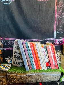 a row of books sitting on a table at Mj s Home in Kalgha