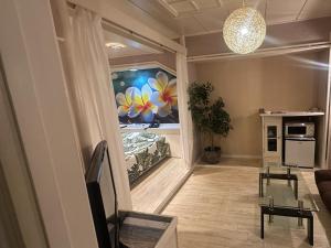a living room with a painting on the wall at Hotel Maile in Tokyo