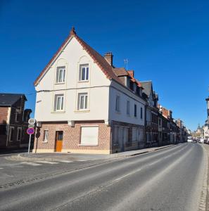 a white building on the side of a street at St FURSY 2 in Péronne