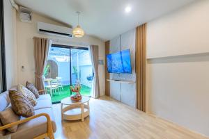 a living room with a couch and a table at Villa Luna and Villa Solara in Koh Samui