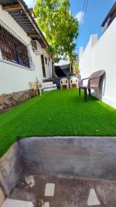 a yard with a bench and green grass at Genovesa Family home in Puerto Ayora