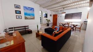 a living room with a couch and a table at Genovesa Family home in Puerto Ayora
