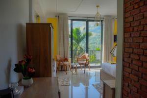 a living room with a table and chairs and a bedroom at 3Arch Eco Cottage Ella in Ella