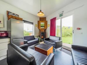 a living room with couches and chairs and a tv at The Bunkhouse - Uk50470 in Greenhaugh