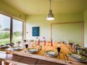 a wooden table with plates and glasses on it at The Bunkhouse - Uk50470 in Greenhaugh