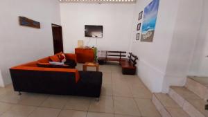 a living room with a couch and a television at Genovesa Family home in Puerto Ayora