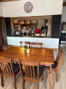 a wooden table and chairs in a restaurant at The Bears in Geeveston