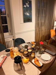 a table with food and drinks and a table with food at Les chambres du Lohan in Daoulas