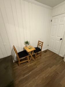 a room with a table and two chairs and a door at April Palace green in Decatur